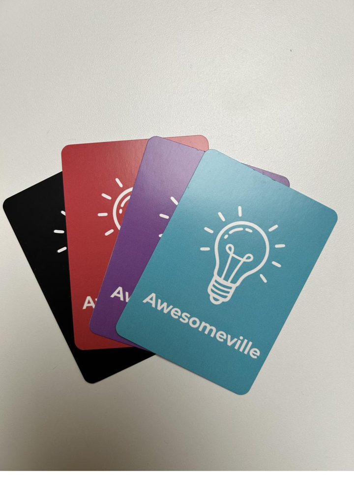 Awesomeville game cards spread on a table