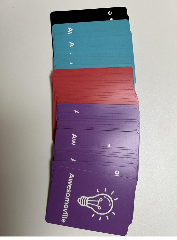 Awesomeville game cards showing the branded backs